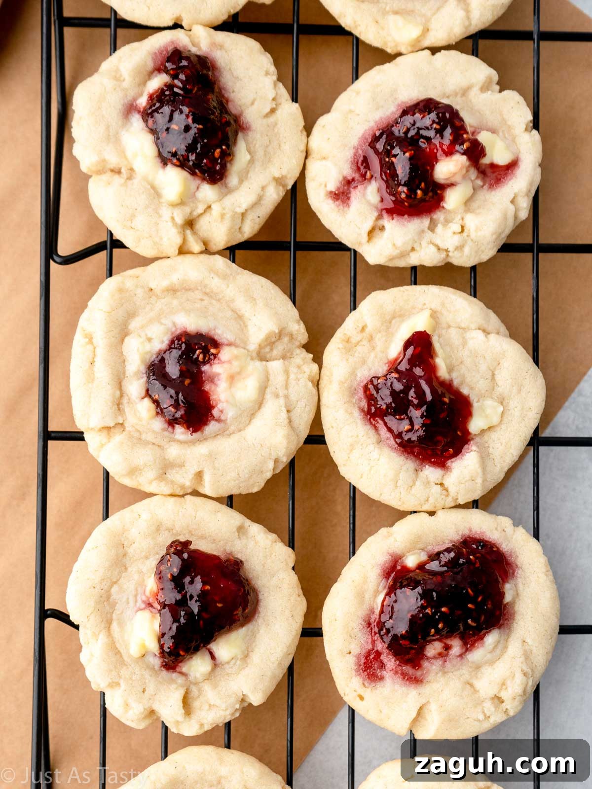 Soft Gluten-Free Raspberry Thumbprint Cookies 10 Raspberry thumbprint cookies on a wire cooling rack.