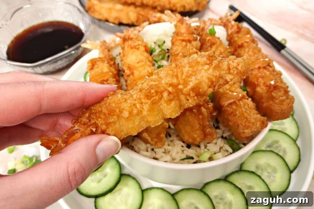Crispy Air-Fryer Tempura Shrimp from Aldi Frozen Pack 3 holding an air fried tempura shrimp