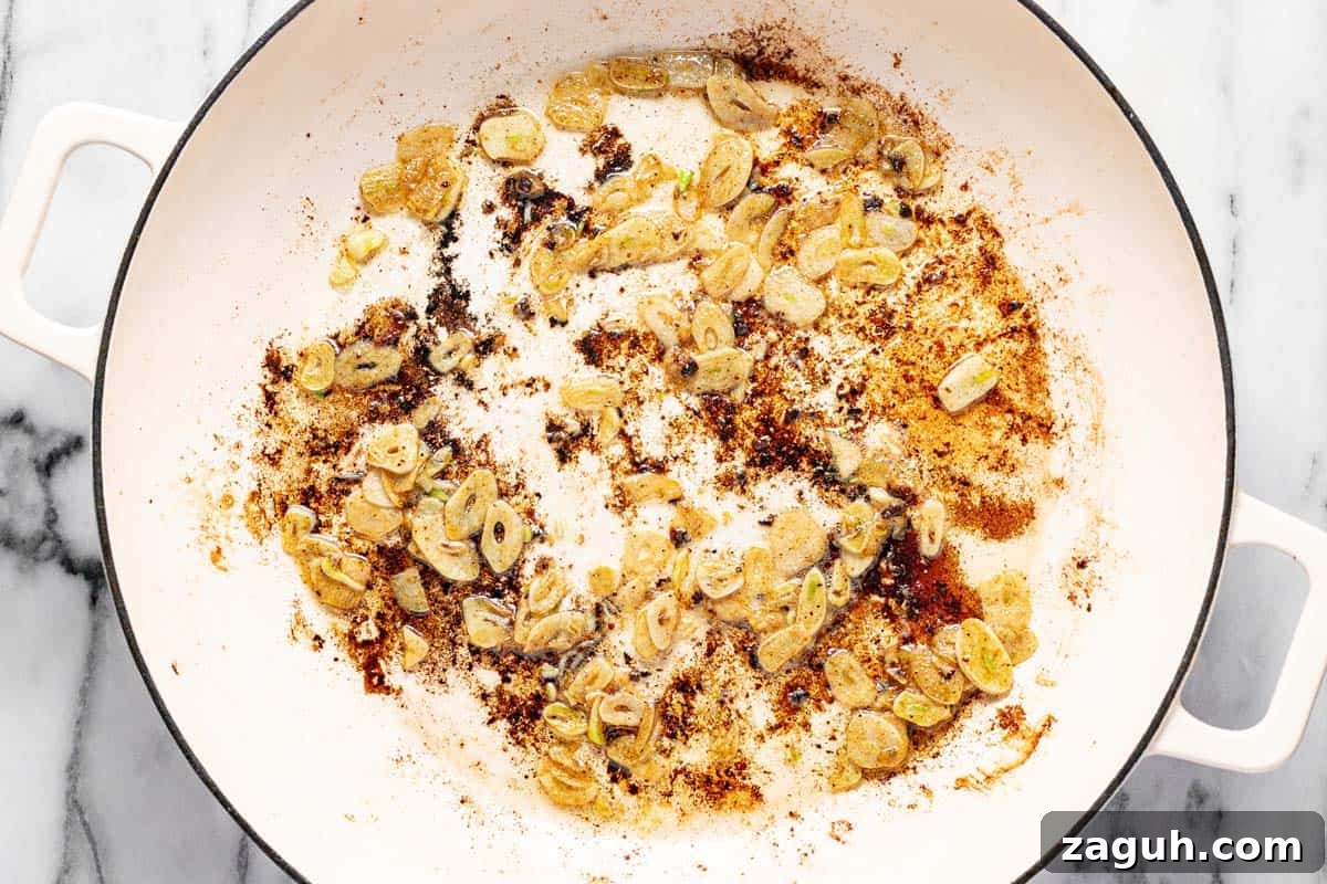 20-Minute Garlic Chicken with Honey Glaze 6 Sliced garlic sauteed in pan drippings in a large saute pan.