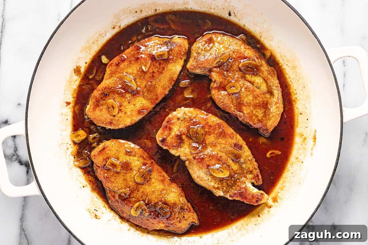20-Minute Garlic Chicken with Honey Glaze 7 Large pan filled with sauteed chicken breast in a honey garlic sauce.