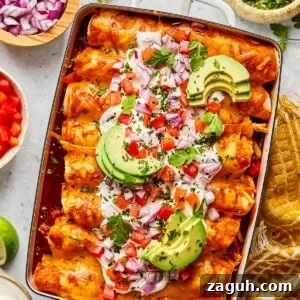 Chicken and black bean enchiladas with toppings in a casserole dish