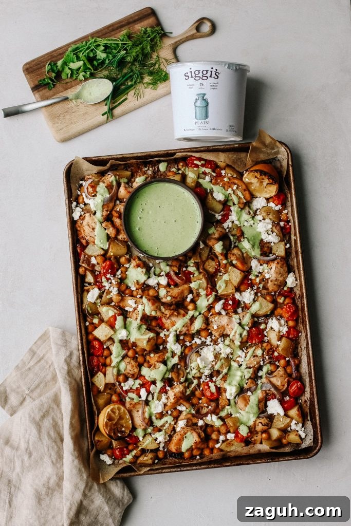 Green Goddess Sheet-Pan Chicken with Roasted Veggies 2 chicken and veggies on sheet pan with green yogurt sauce
