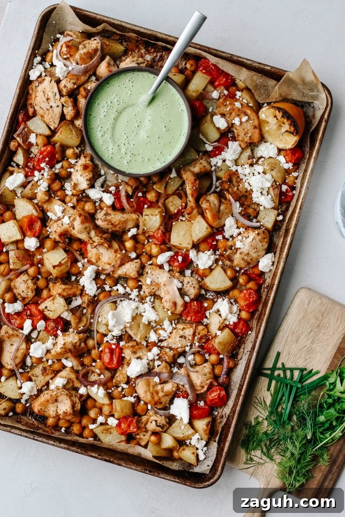 Green Goddess Sheet-Pan Chicken with Roasted Veggies 3 chicken and veggies on sheet pan with green yogurt sauce with herbs on wood cutting board