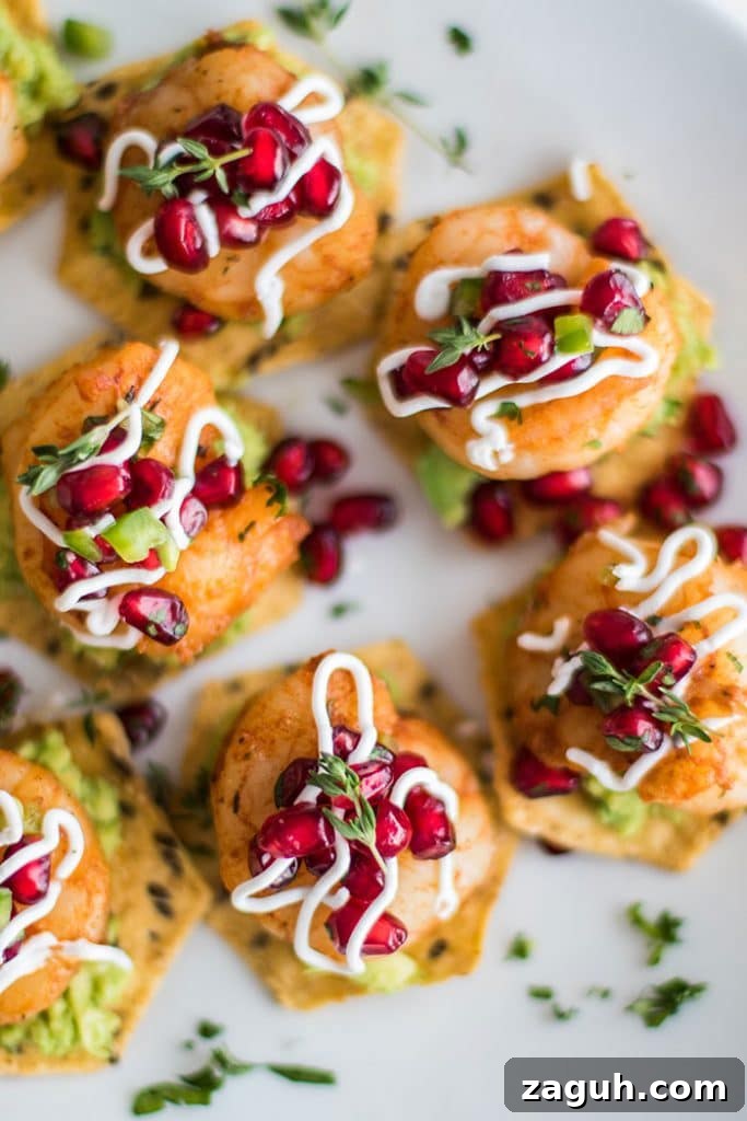 Mini Shrimp Tostadas / The perfect healthy party appetizer! Blackened shrimp, guacamole, and a tangy pomegranate salsa.