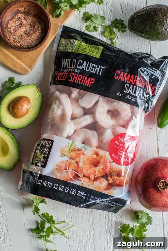 Mini Shrimp Tostadas with Pomegranate Guacamole / The perfect healthy party appetizer! Blackened shrimp, guacamole, and a tangy pomegranate salsa.