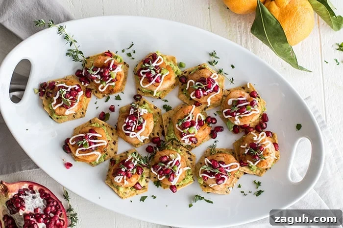Blackened Shrimp Tostadas with Pomegranate Guacamole / The perfect healthy party appetizer! Blackened shrimp, guacamole, and a tangy pomegranate salsa.
