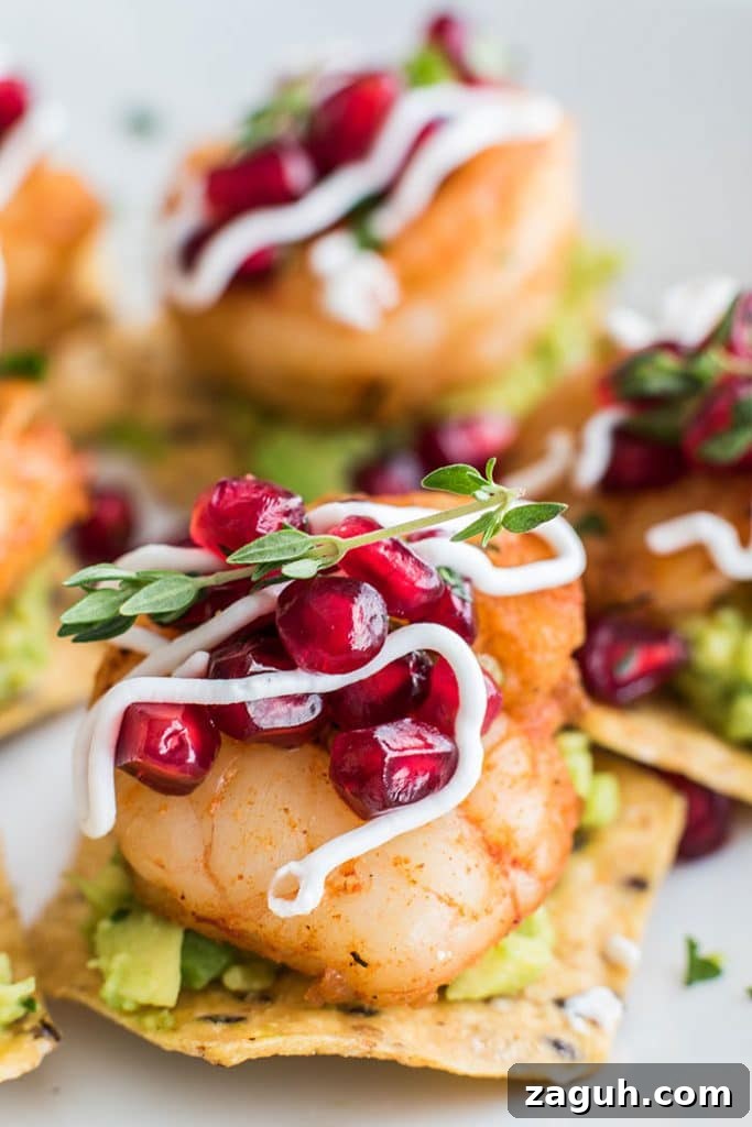 Mini Shrimp Tostadas with Pomegranate Guacamole / The perfect healthy party appetizer! Blackened shrimp, guacamole, and a tangy pomegranate salsa.