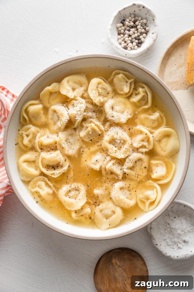 Tortellini in Rich Bone Broth Recipe: Comforting Italian Soup 4 Countertop set with a bowl of tortellini warmed in bone broth, black pepper, and Parmesan cheese.