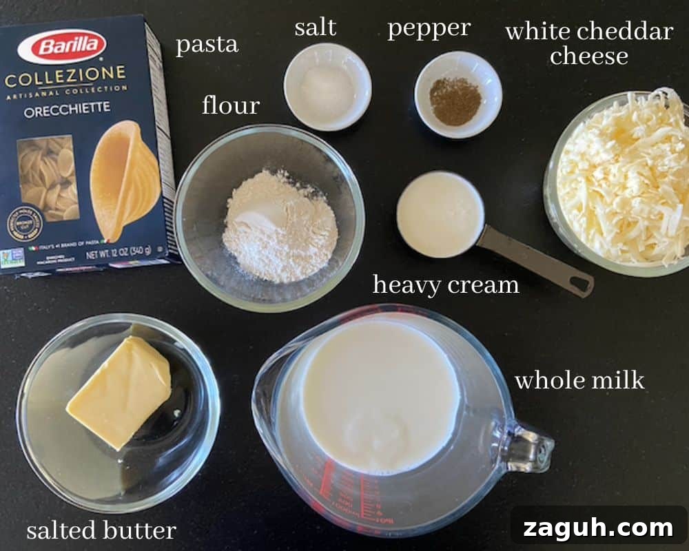 Creamy White Cheddar Mac and Cheese Recipe for Dinner 3 creamy white cheddar mac and cheese ingredients on black countertop with text