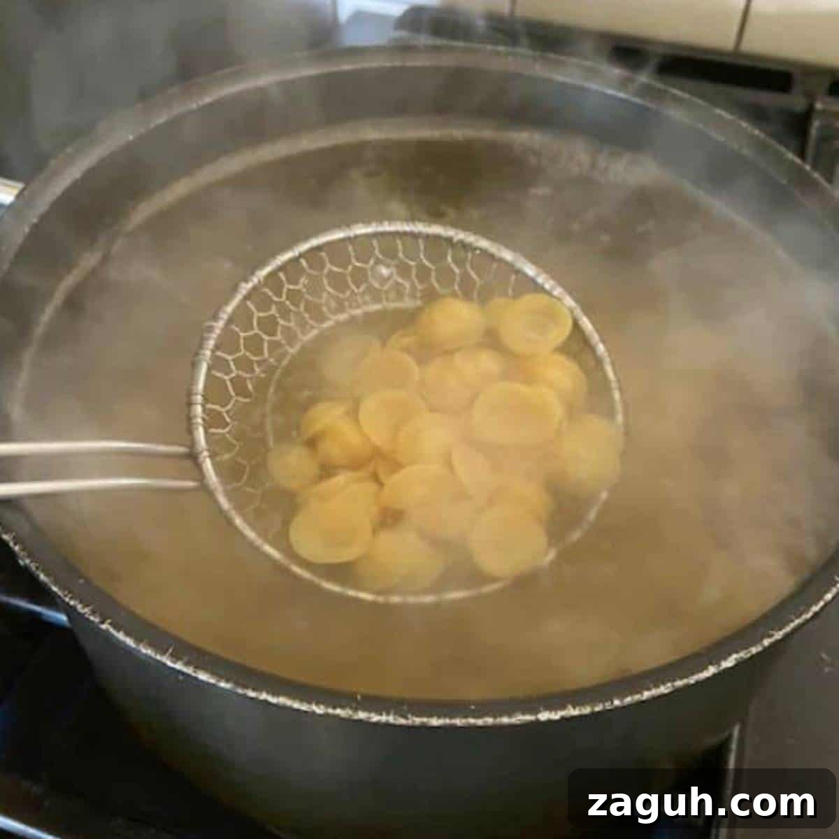 Creamy White Cheddar Mac and Cheese Recipe for Dinner 4 Pasta boiling in pot.