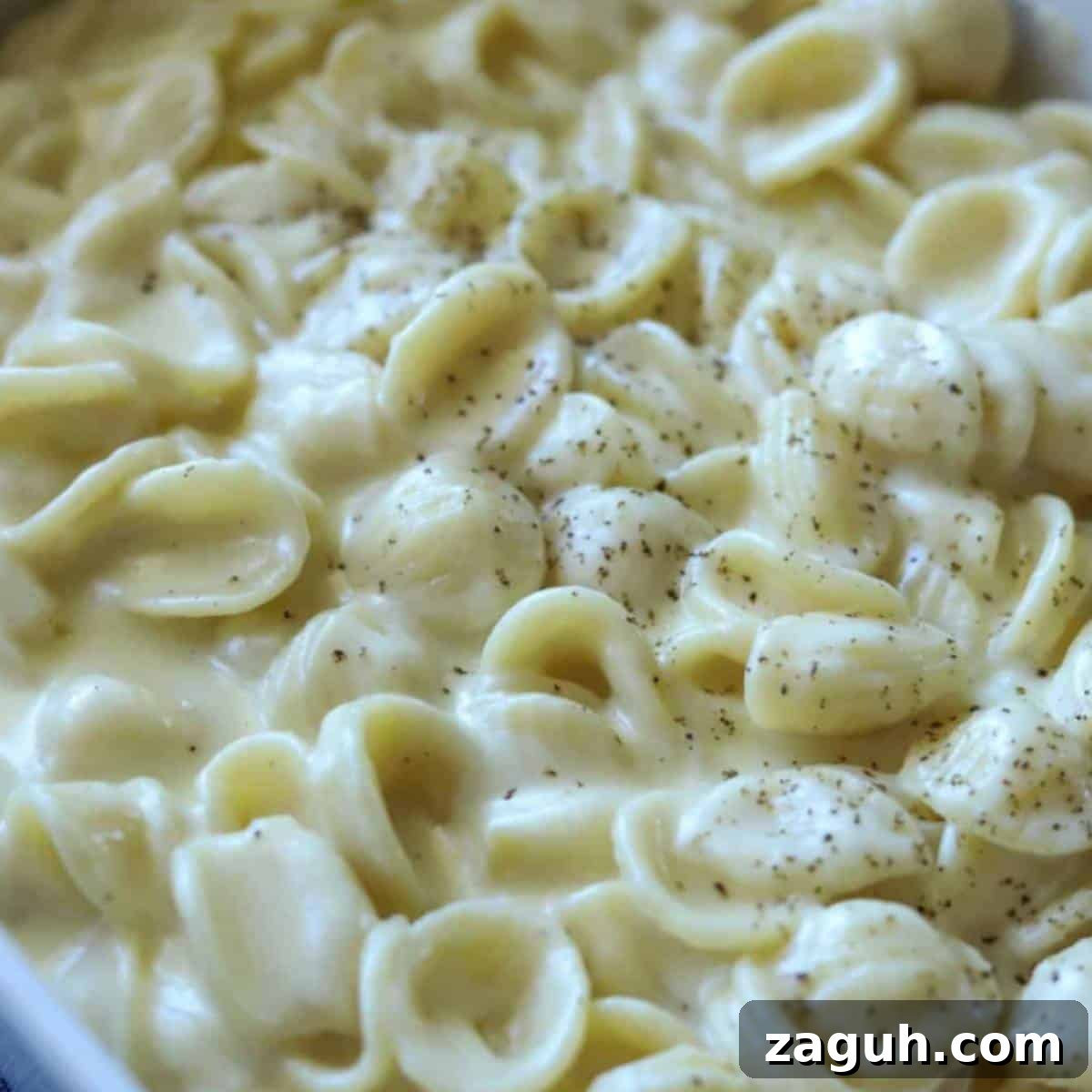 Creamy White Cheddar Mac and Cheese Recipe for Dinner 9 White cheddar mac and cheese sprinkled with pepper.