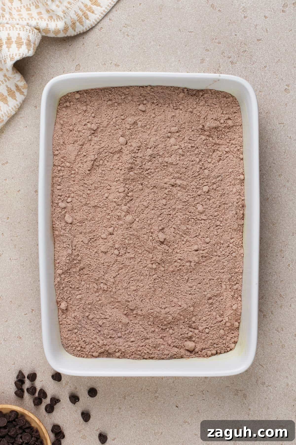 Decadent Chocolate Dump Cake Recipe That Melts in Minutes 6 Chocolate dump cake dry ingredients in a white baking dish.