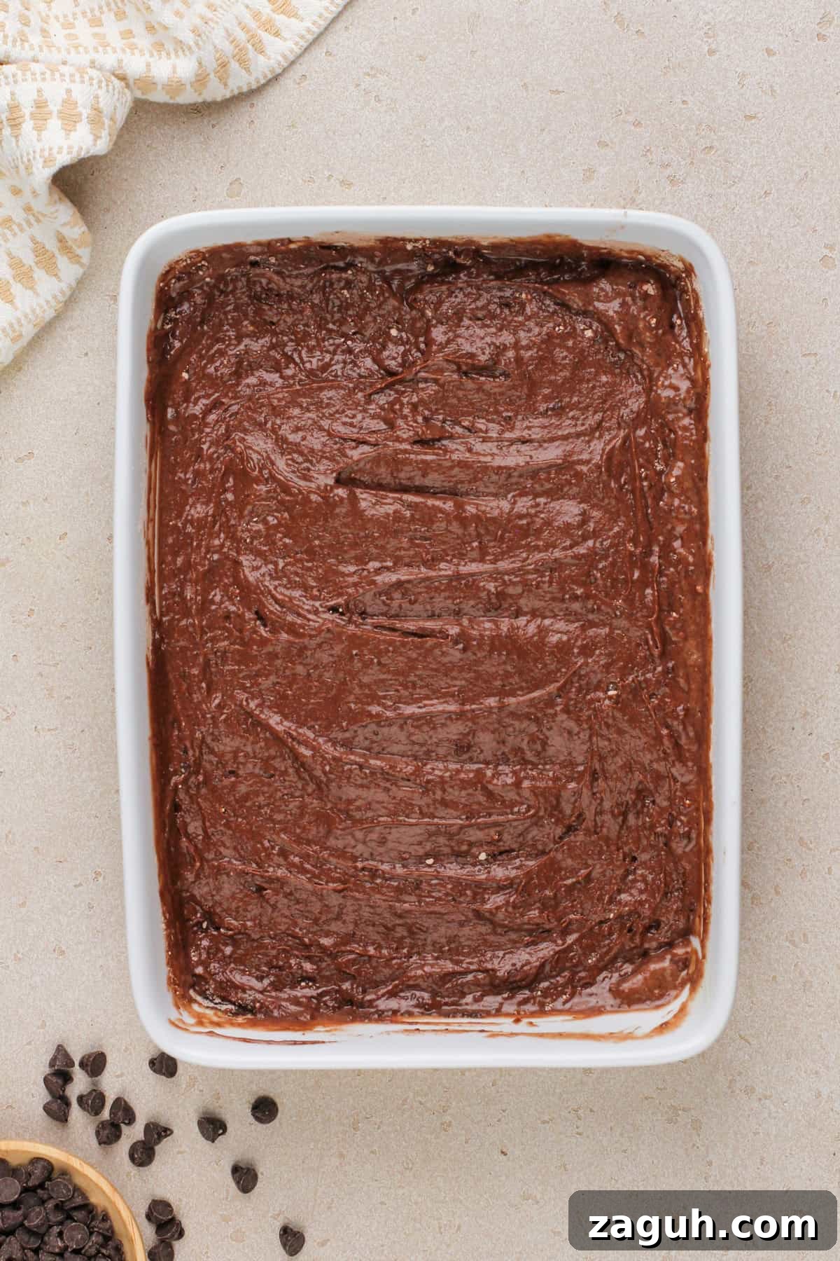 Decadent Chocolate Dump Cake Recipe That Melts in Minutes 7 Batter for chocolate dump cake spread into a white baking dish.