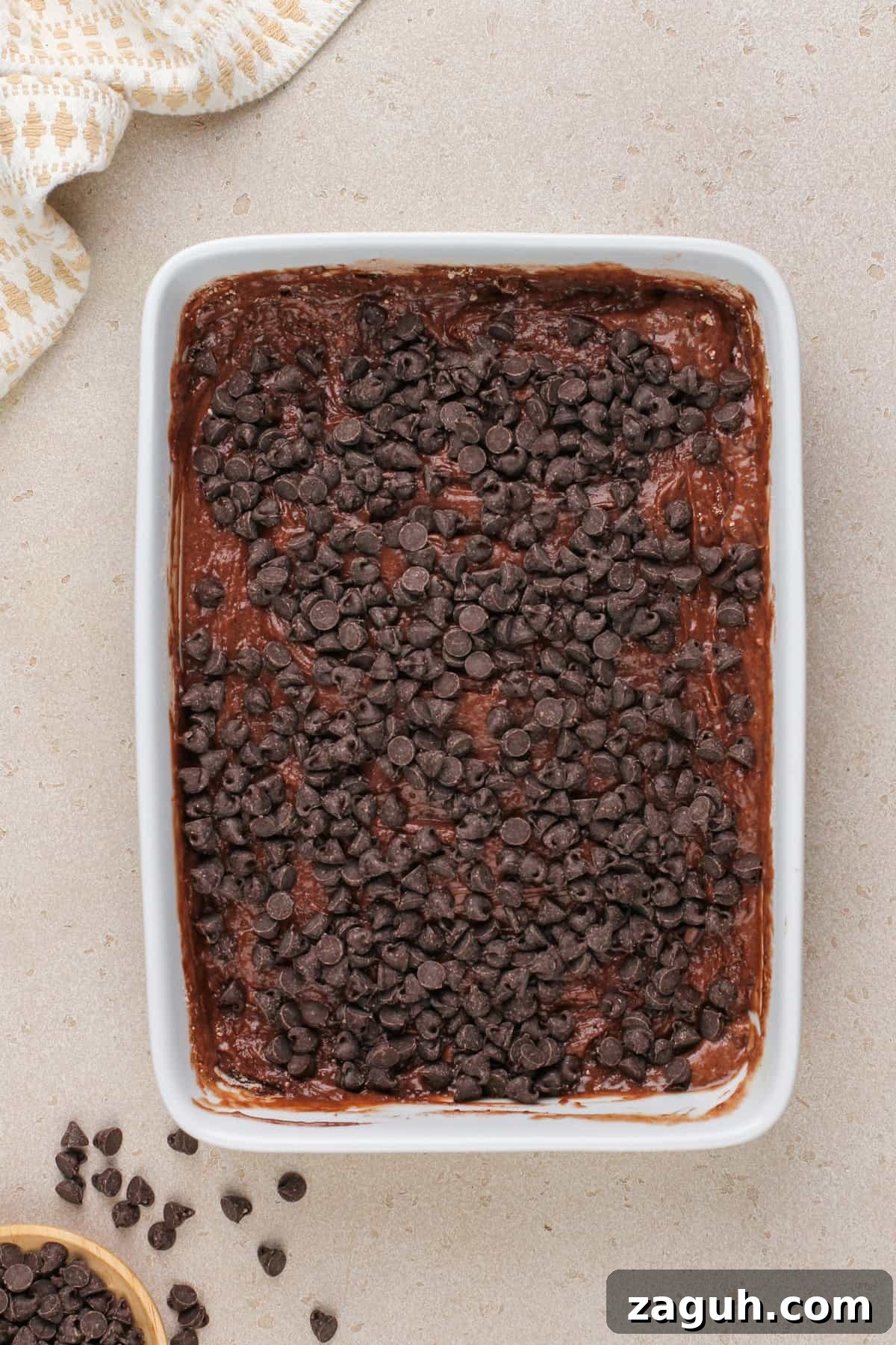Decadent Chocolate Dump Cake Recipe That Melts in Minutes 8 Assembled chocolate dump cake in a white baking dish, ready to go in the oven.