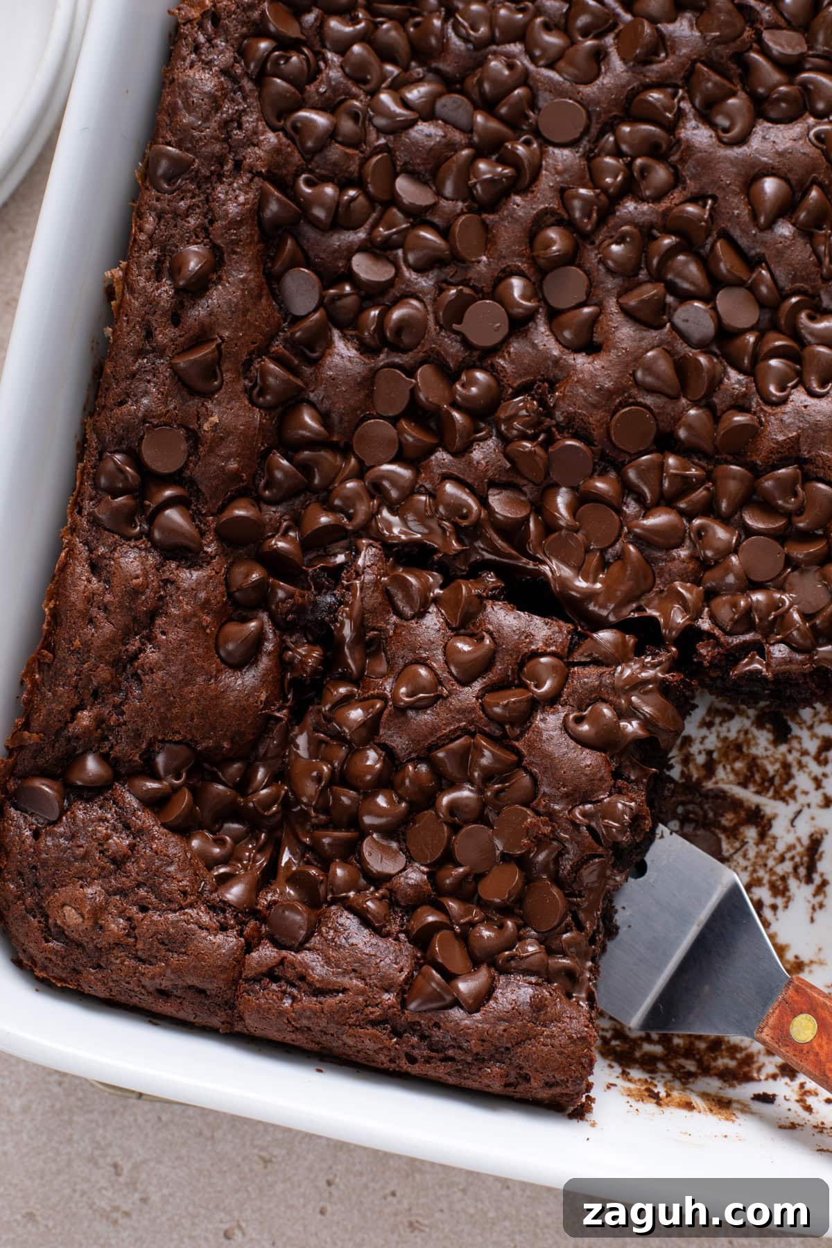 Decadent Chocolate Dump Cake Recipe That Melts in Minutes 10 Sliced chocolate dump cake in a white baking dish.
