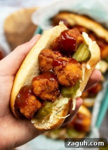 Crispy Popcorn Chicken Sandwich Recipe for Ultimate Flavor 7 overhead shot of holding sandwich close to camera with more blurred in background