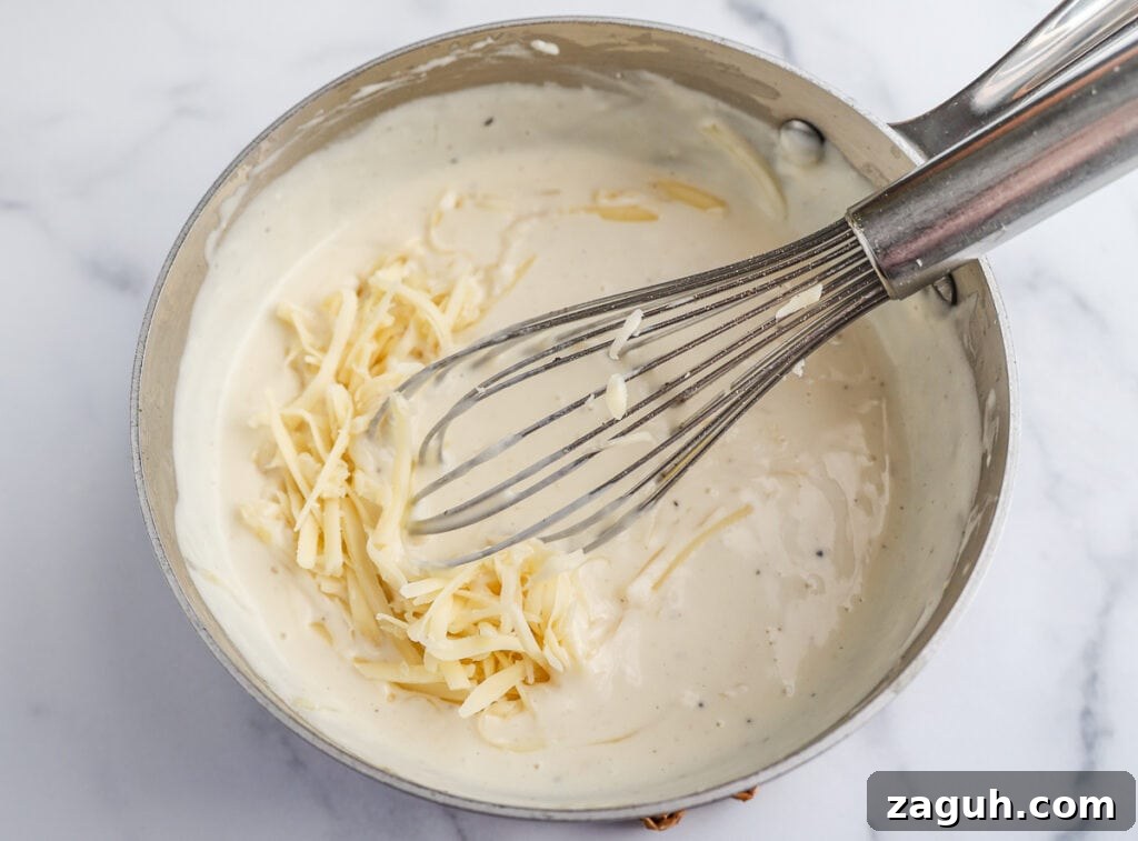 Creamy Broccoli and Cheese Casserole Topped with Ritz Crackers 5 Whisking shredded cheese into the white sauce.