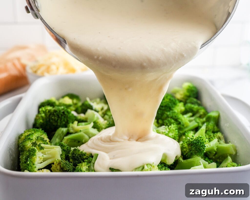 Creamy Broccoli and Cheese Casserole Topped with Ritz Crackers 6 Pouring the cheese sauce over the steamed broccoli for an easy casserole. Will be topped with Ritz crackers.