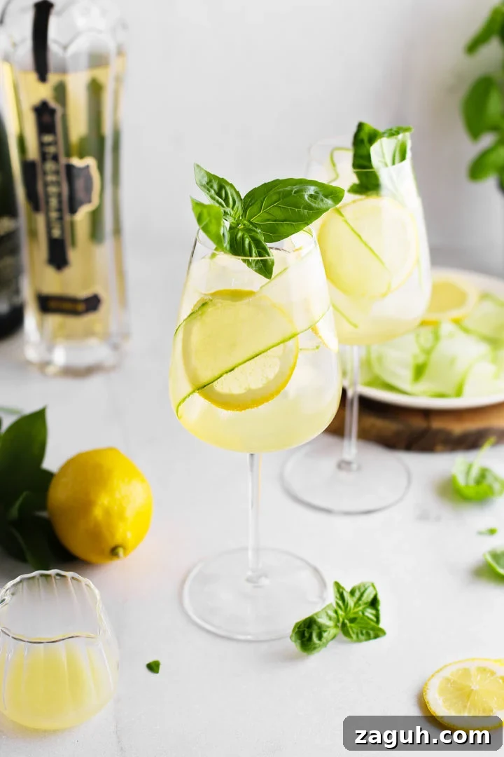 St-Germain Spritz Cocktail Recipe: How to Make a Bright French Spritz 11 two glasses of st. germain spritz next to fresh lemons and basil sprigs