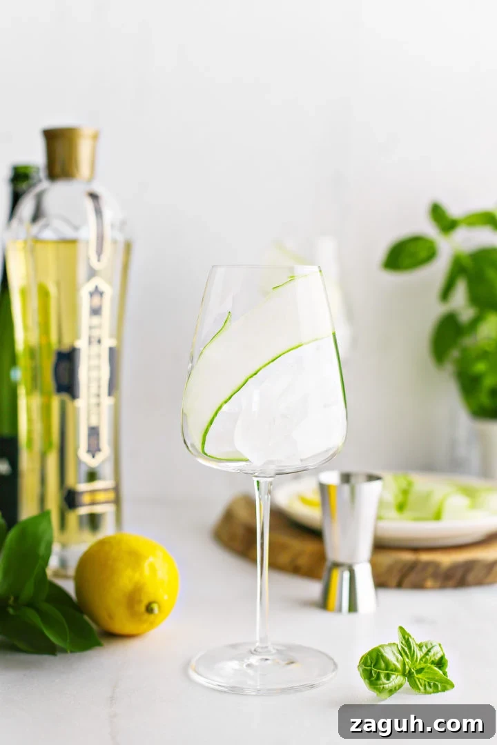 St-Germain Spritz Cocktail Recipe: How to Make a Bright French Spritz 6 step photo showing how to add a cucumber ribbon garnish to a st germain spritz