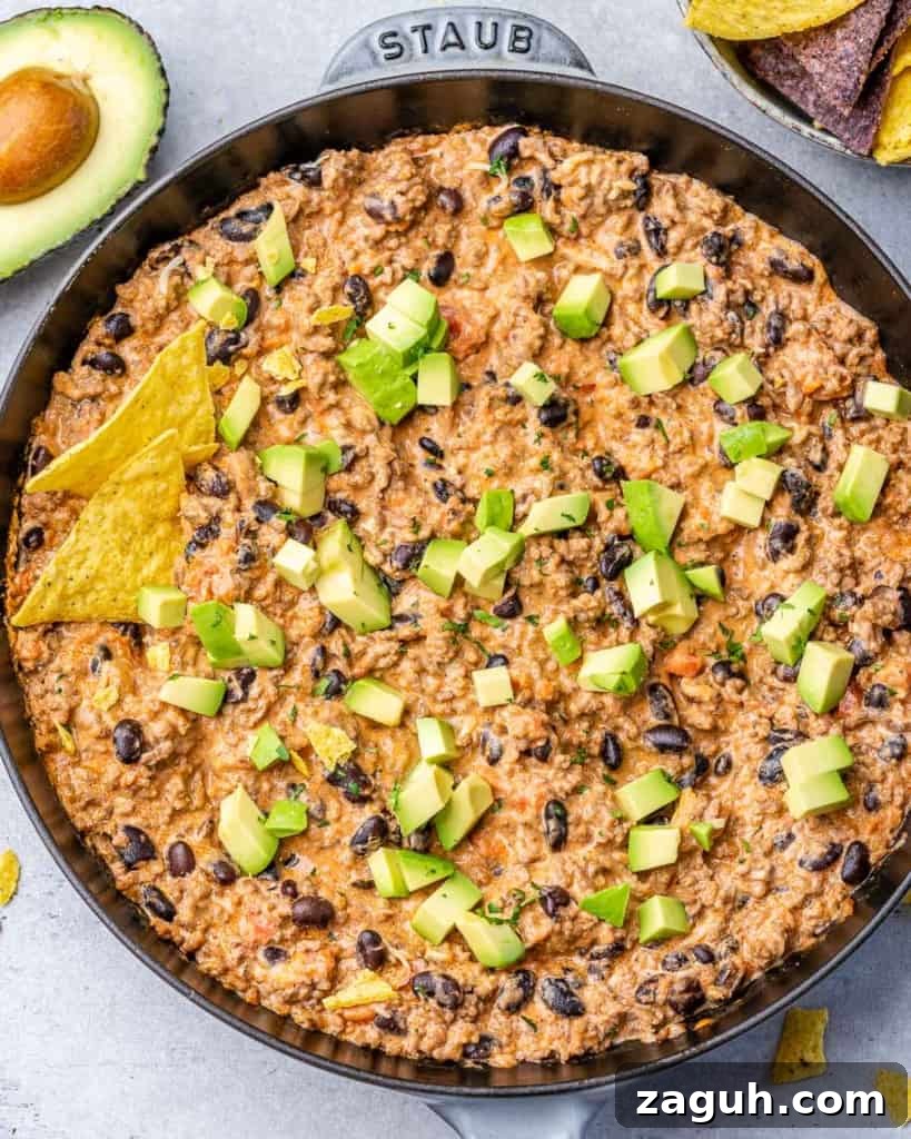 Spicy Chili Cheese Dip Recipe for Parties and Game Day 2 Chili cheese dip topped with avocado.