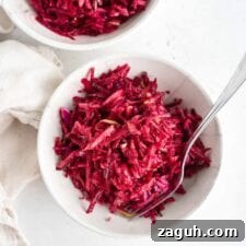 Crisp Apple and Beet Slaw Recipe for Fresh, Tangy Sides 6 Overhead shot of two bowls of beet, apple and cabbage slaw in bowls.