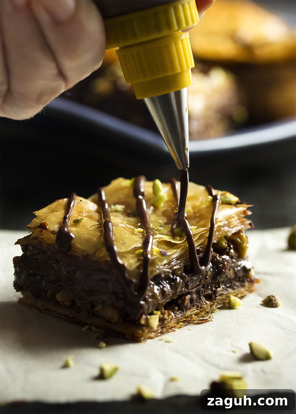 Pistachio Chocolate Baklava: Decadent Layered Dessert Recipe 3 Layers of fillo, pistachios, pecans, and chocolate make this baklava extra decadent and rich.