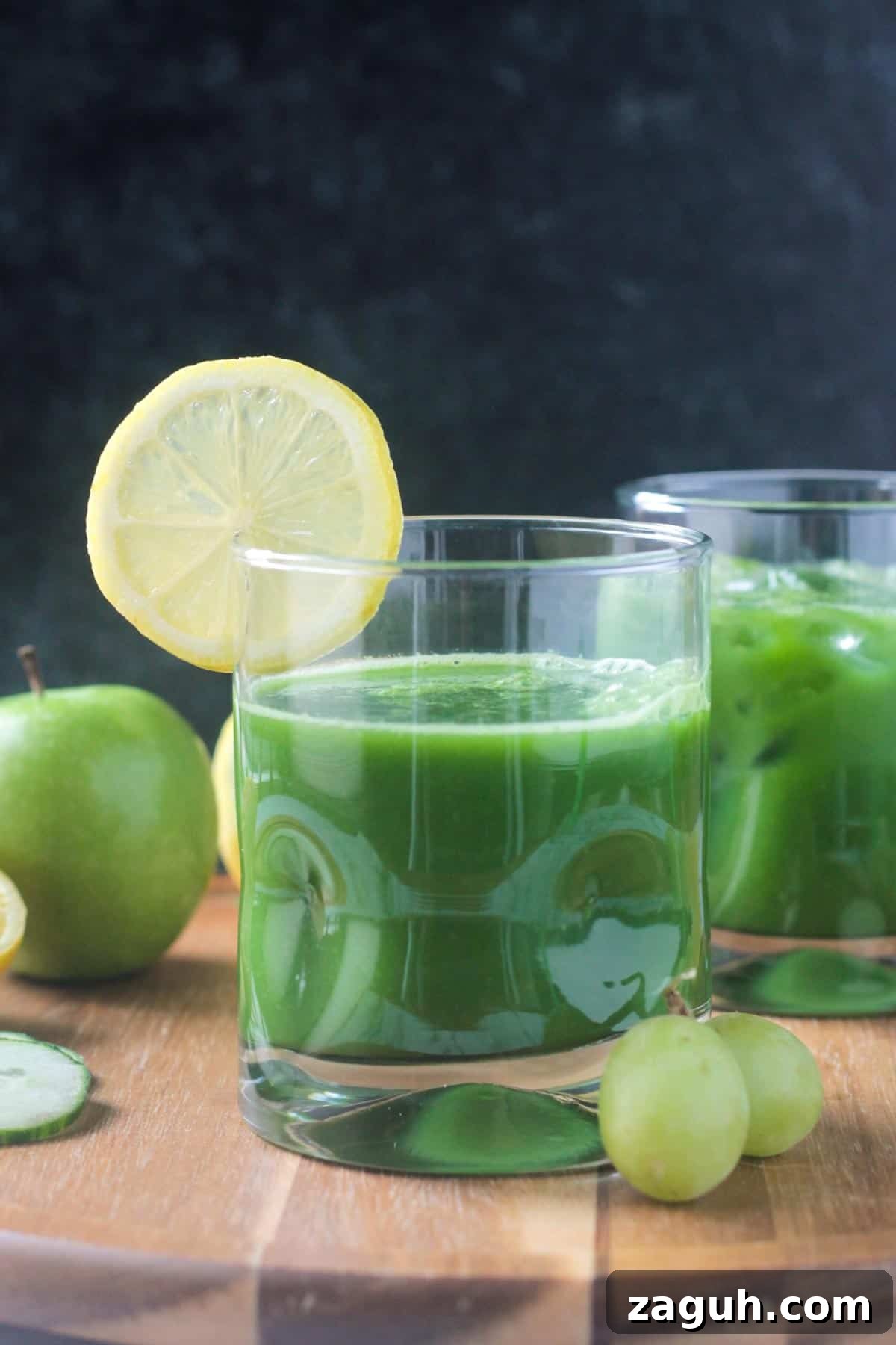 Fresh Green Blender Juice Recipe for Energy and Detox 2 Green juice in a glass with a lemon slice on the rim.