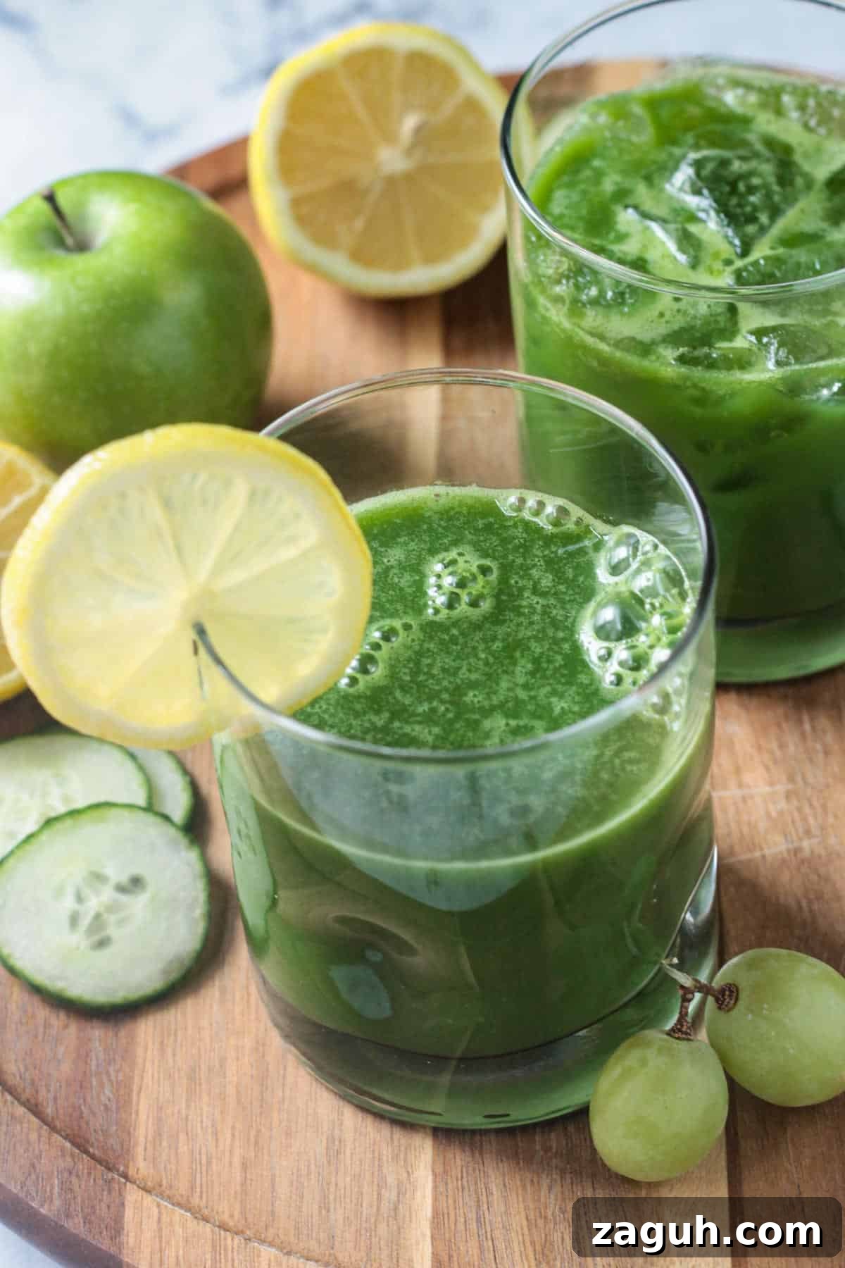 Fresh Green Blender Juice Recipe for Energy and Detox 6 Two glasses of green drink with lemon slices on the rims.