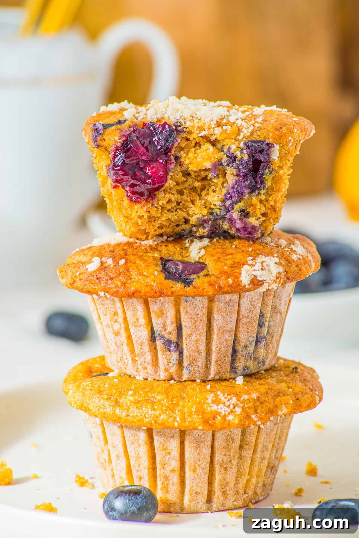 Gluten free blueberry cottage cheese muffins with streusel topping on a plate.