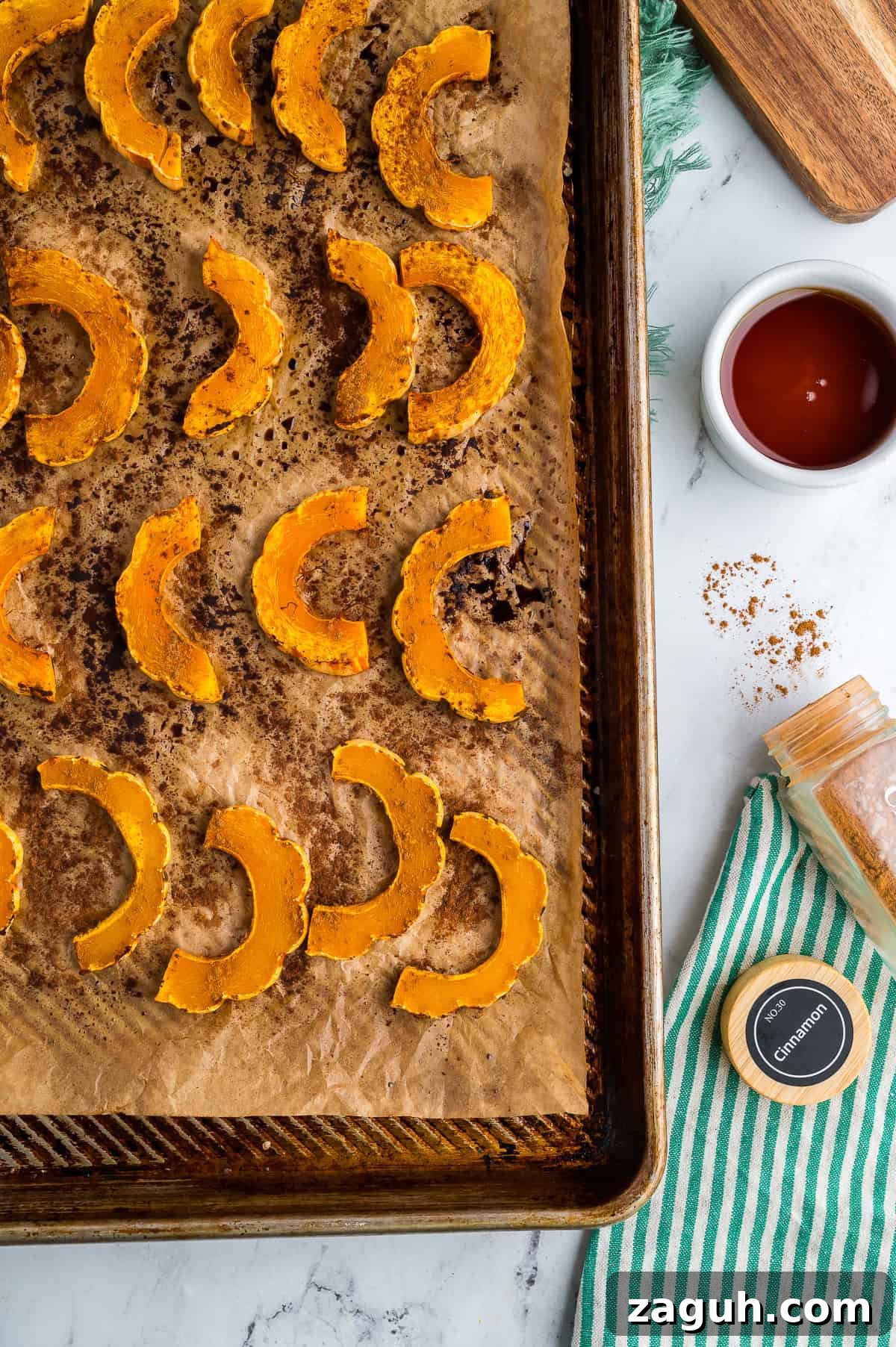 Roasted delicata squash on a baking sheet.
