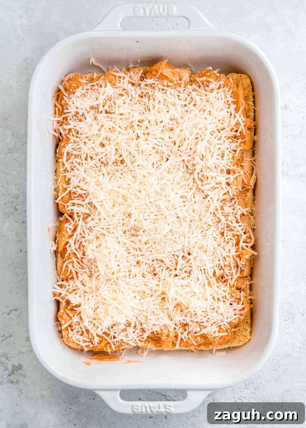 Spicy Buffalo Chicken Sliders with Blue Cheese Slaw 10 creamy buffalo chicken and shredded mozzarella on buns in a white casserole dish