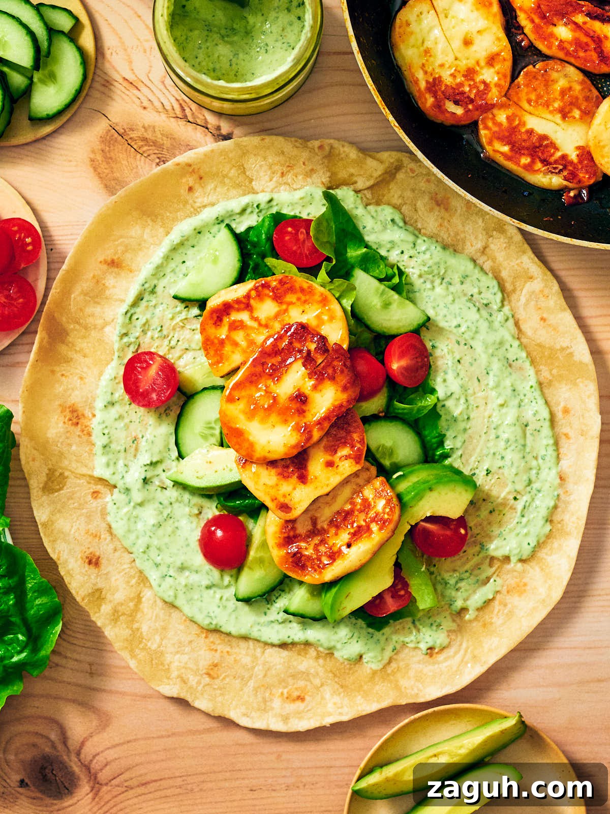 3-Minute Cilantro Yogurt Sauce Recipe for Tacos & Grills 11 Cilantro yogurt sauce on a wrap with Halloumi, avocado, cucumbers, tomatoes, and lettuce.