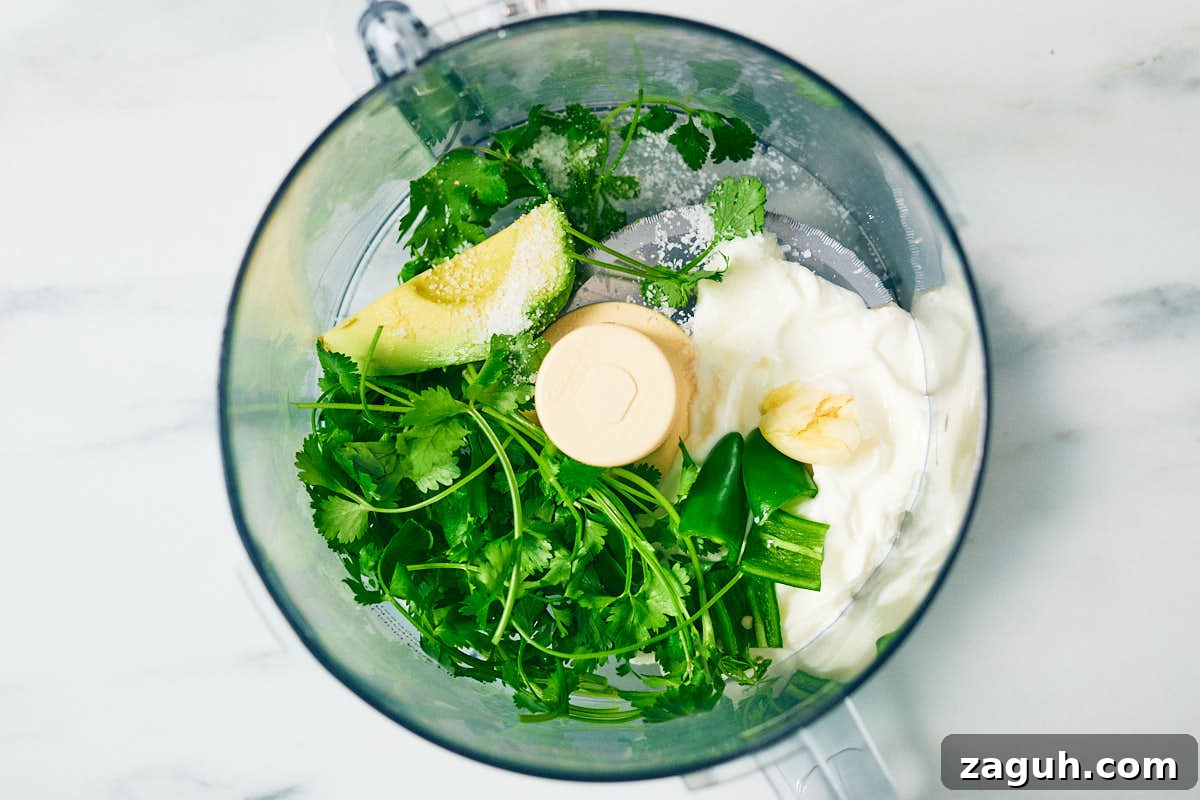 3-Minute Cilantro Yogurt Sauce Recipe for Tacos & Grills 7 Cilantro, Greek yogurt, avocado, jalapeno, garlic, and salt in a food processor.