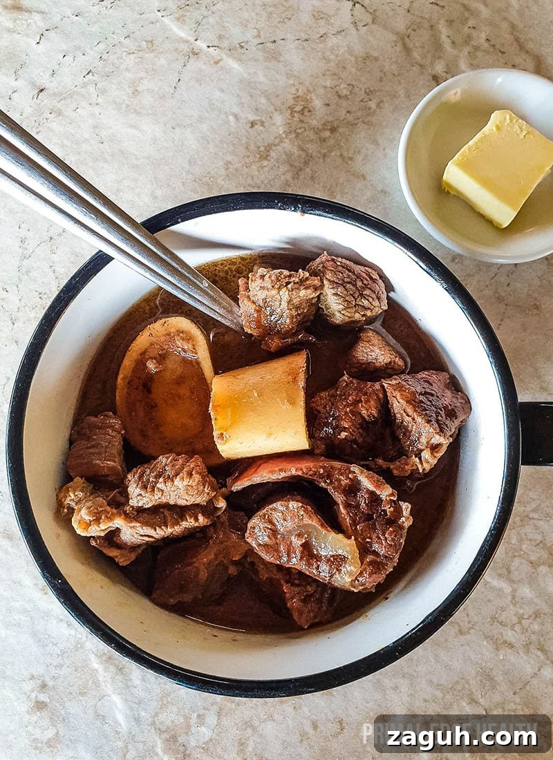 Carnivore Lunch Ideas for Simple Weekly Meal Planning 3 A cup of carnivore beef stew on a white surface.