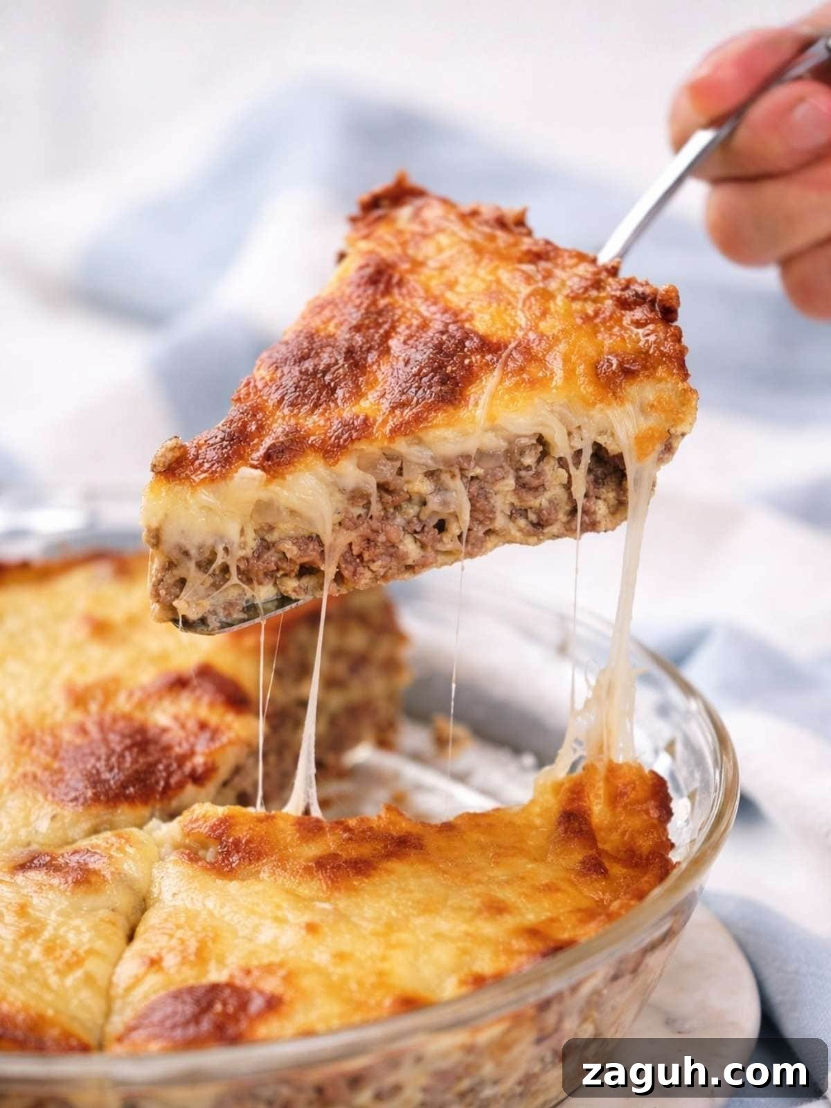 Carnivore Lunch Ideas for Simple Weekly Meal Planning 9 A slice of easy cheeseburger pie with a browned, melted cheese topping.