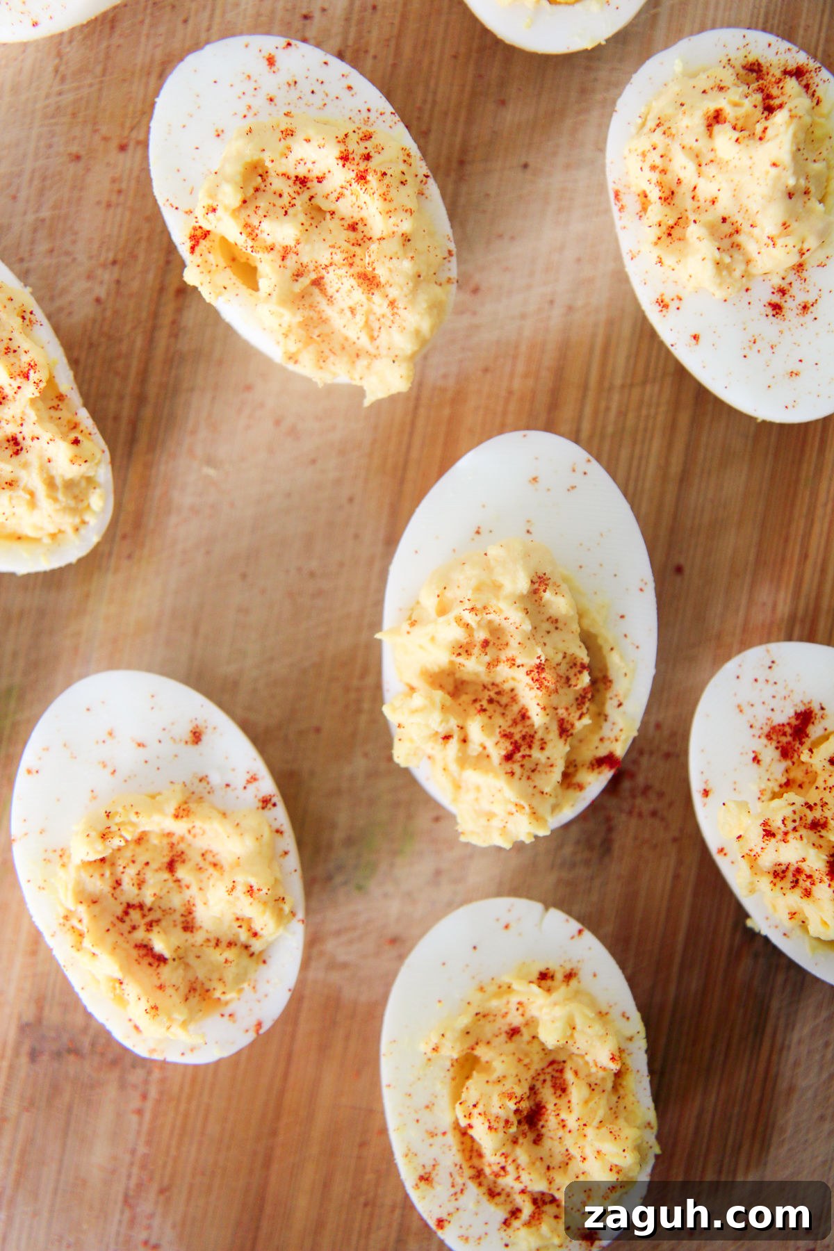 Perfect Classic Deviled Eggs Recipe for Parties and Holidays 4 deviled eggs on a wood board