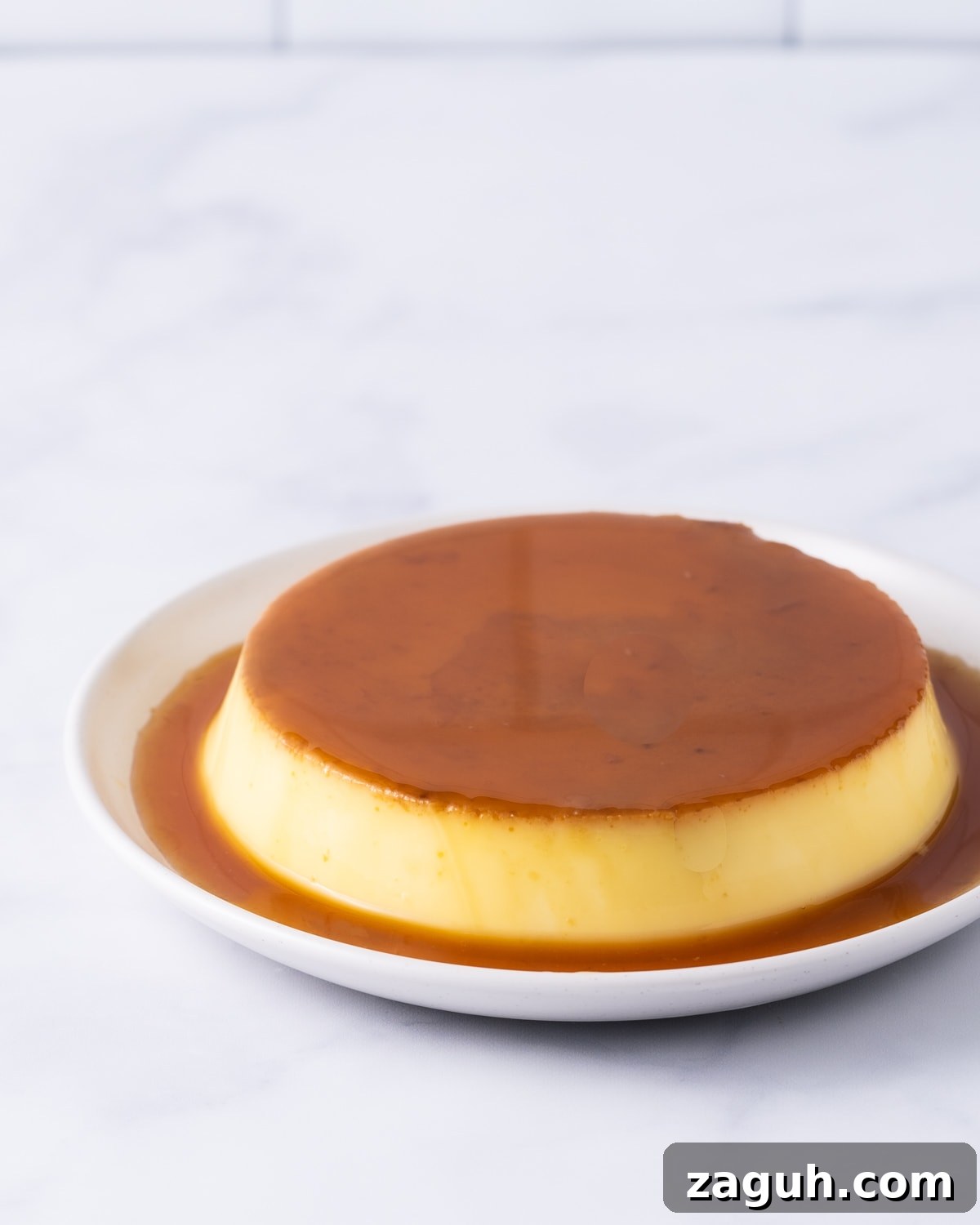 Creamy Vietnamese Bánh Flan Recipe — Classic Caramel Custard 2 Banh flan on a white plate.