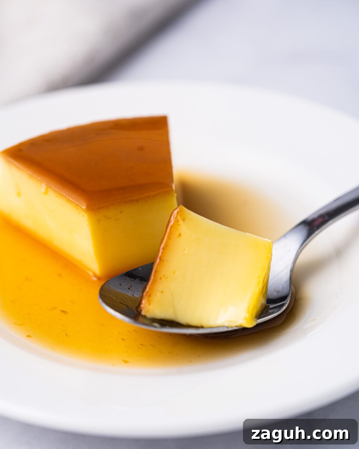Creamy Vietnamese Bánh Flan Recipe — Classic Caramel Custard 3 Slice of banh flan with spoon scooping it.