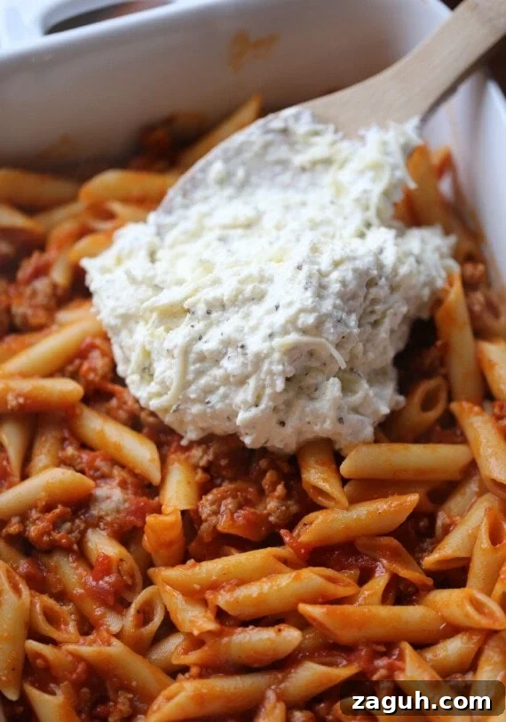Creamy Baked Mostaccioli with Melted Cheese 9 Ricotta cheese is spread over top of pasta tossed in meat sauce.