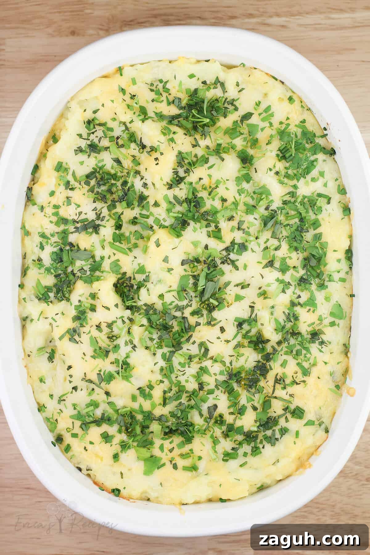 Creamy Gruyère, Garlic & Gouda Mashed Potatoes Recipe 11 top down view of cooked mashed potatoes with cheese and herbs