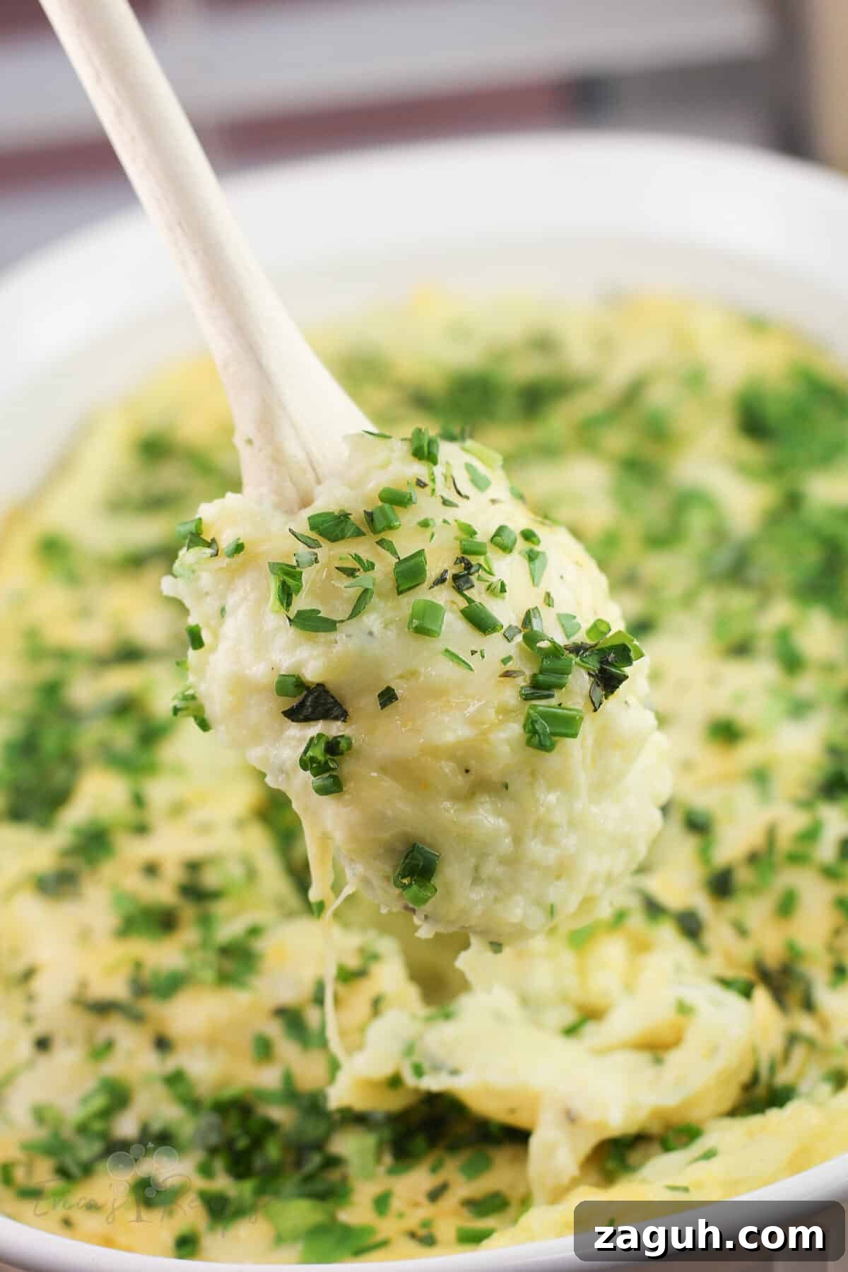 Creamy Gruyère, Garlic & Gouda Mashed Potatoes Recipe 3 wood spoon holding gruyere and gouda mashed potatoes