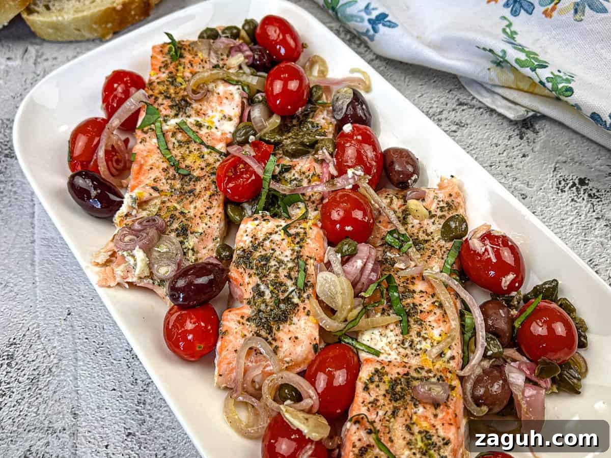 31 Bold Seafood Recipes for Big Flavor with Simple Ingredients 2 Mediterranean Salmon on a white rectangular plate.
