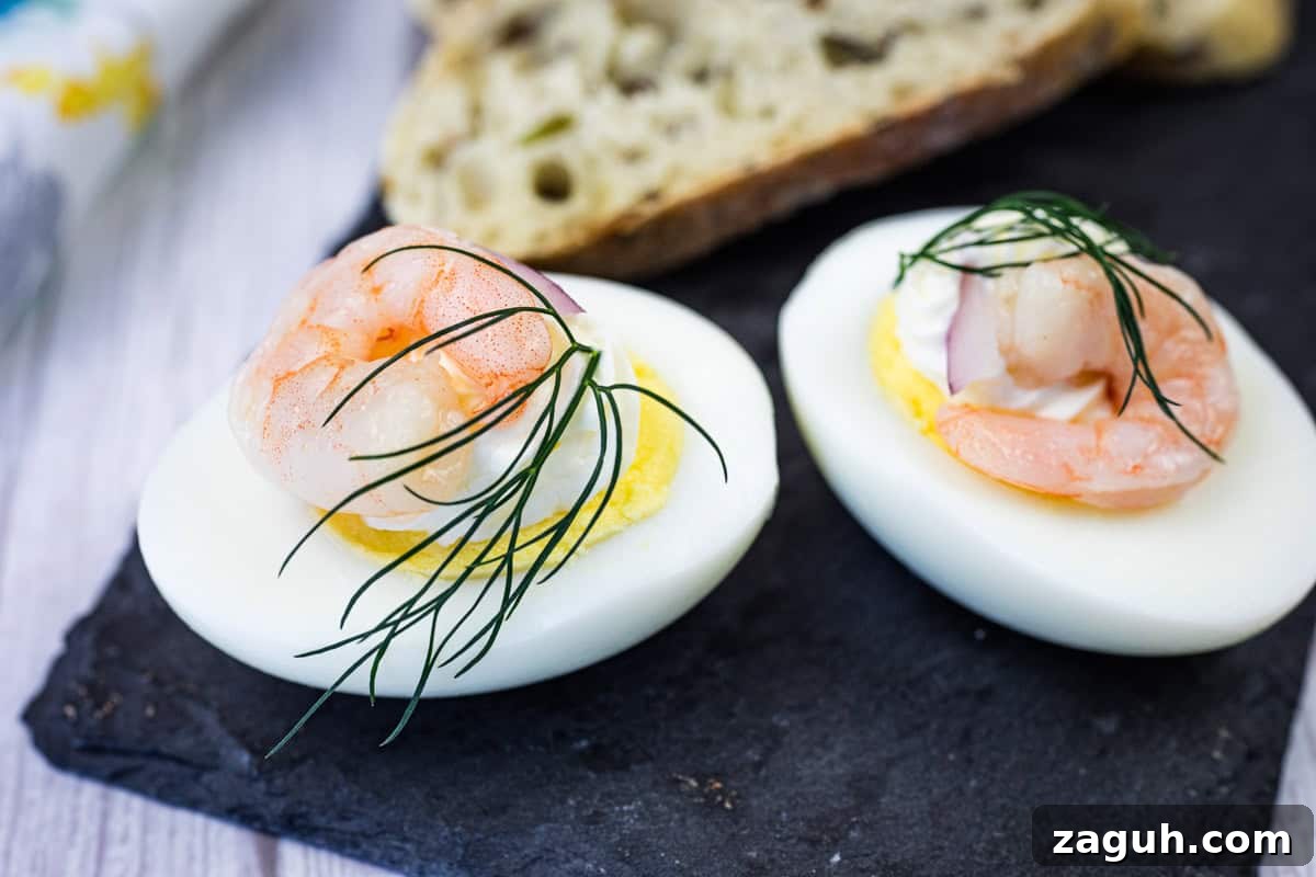 31 Bold Seafood Recipes for Big Flavor with Simple Ingredients 15 Two Pickled Shrimp Egg Shooter halves were placed on a slate board, next to slices of bread.
