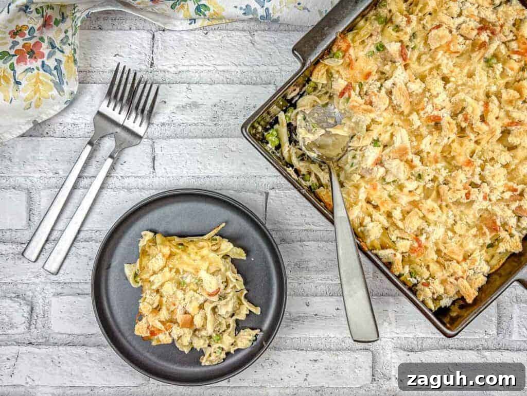 31 Bold Seafood Recipes for Big Flavor with Simple Ingredients 16 Top-down shot of Tuna Noodle Casserole on a dish with a small portion on a black plate.