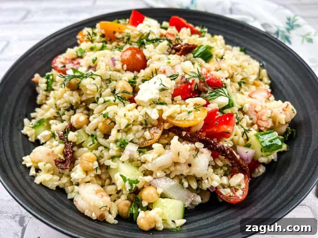 31 Bold Seafood Recipes for Big Flavor with Simple Ingredients 21 A bowl of Mediterranean orzo salad on a black plate.