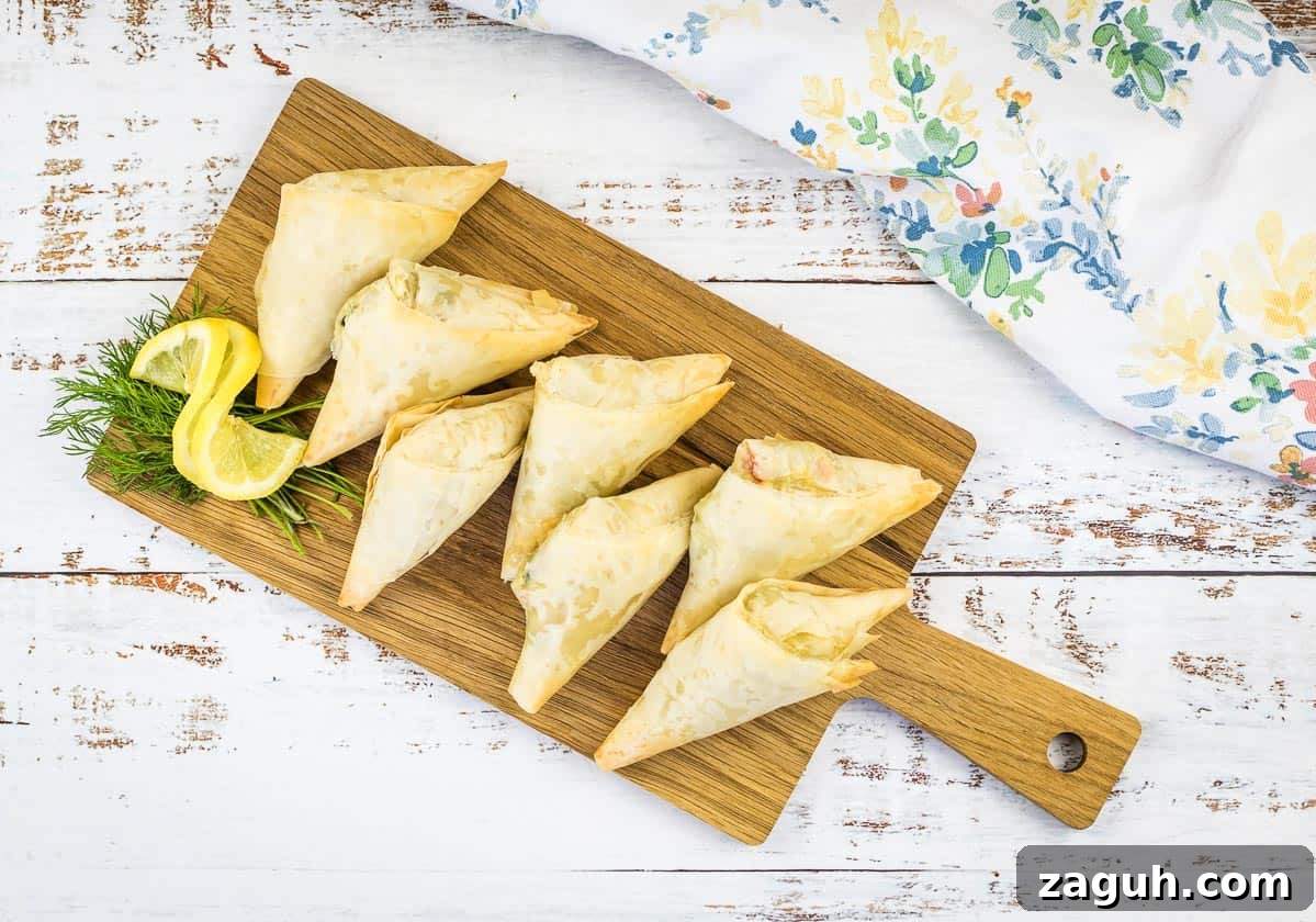 31 Bold Seafood Recipes for Big Flavor with Simple Ingredients 23 Crab Spanakopita triangles on a cutting board.