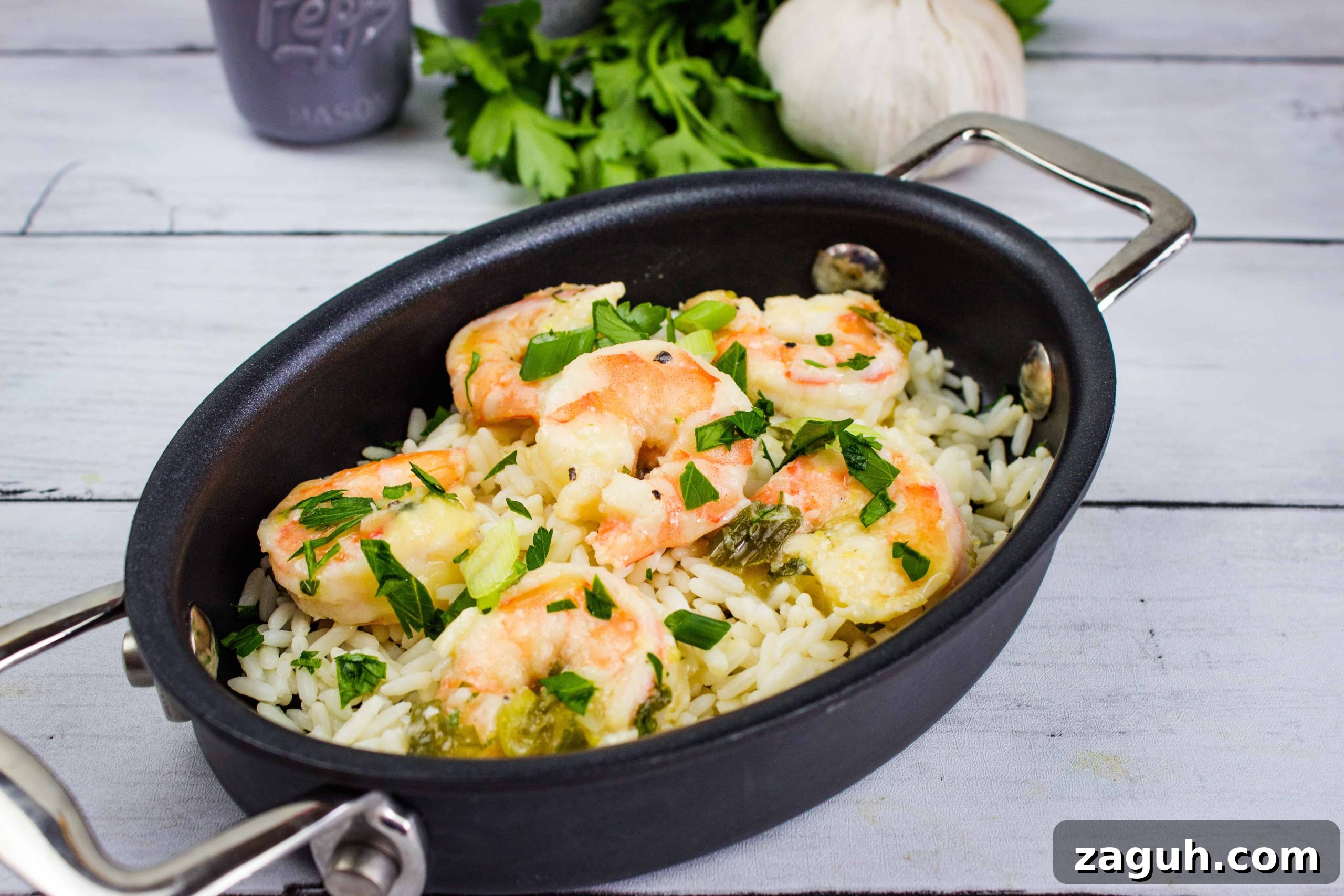 31 Bold Seafood Recipes for Big Flavor with Simple Ingredients 6 Fresh shrimp with rice, herbs, and vegetables in a black cooking skillet. Perfect for quick, flavorful meals.