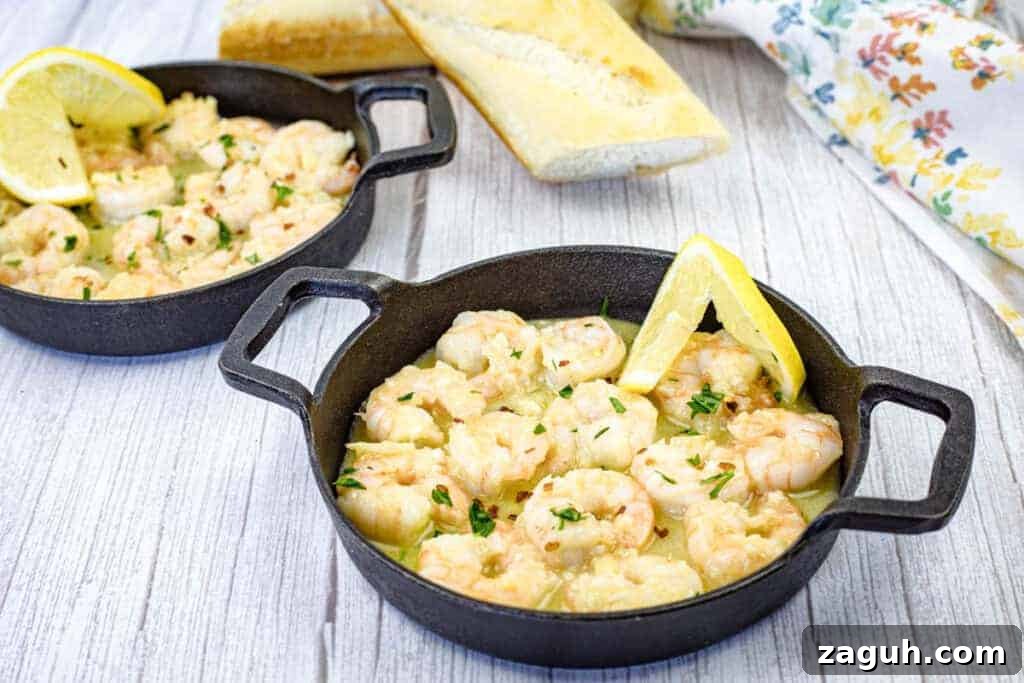 31 Bold Seafood Recipes for Big Flavor with Simple Ingredients 10 Two cast iron skillets contain shrimp scampi garnished with lemon wedges.