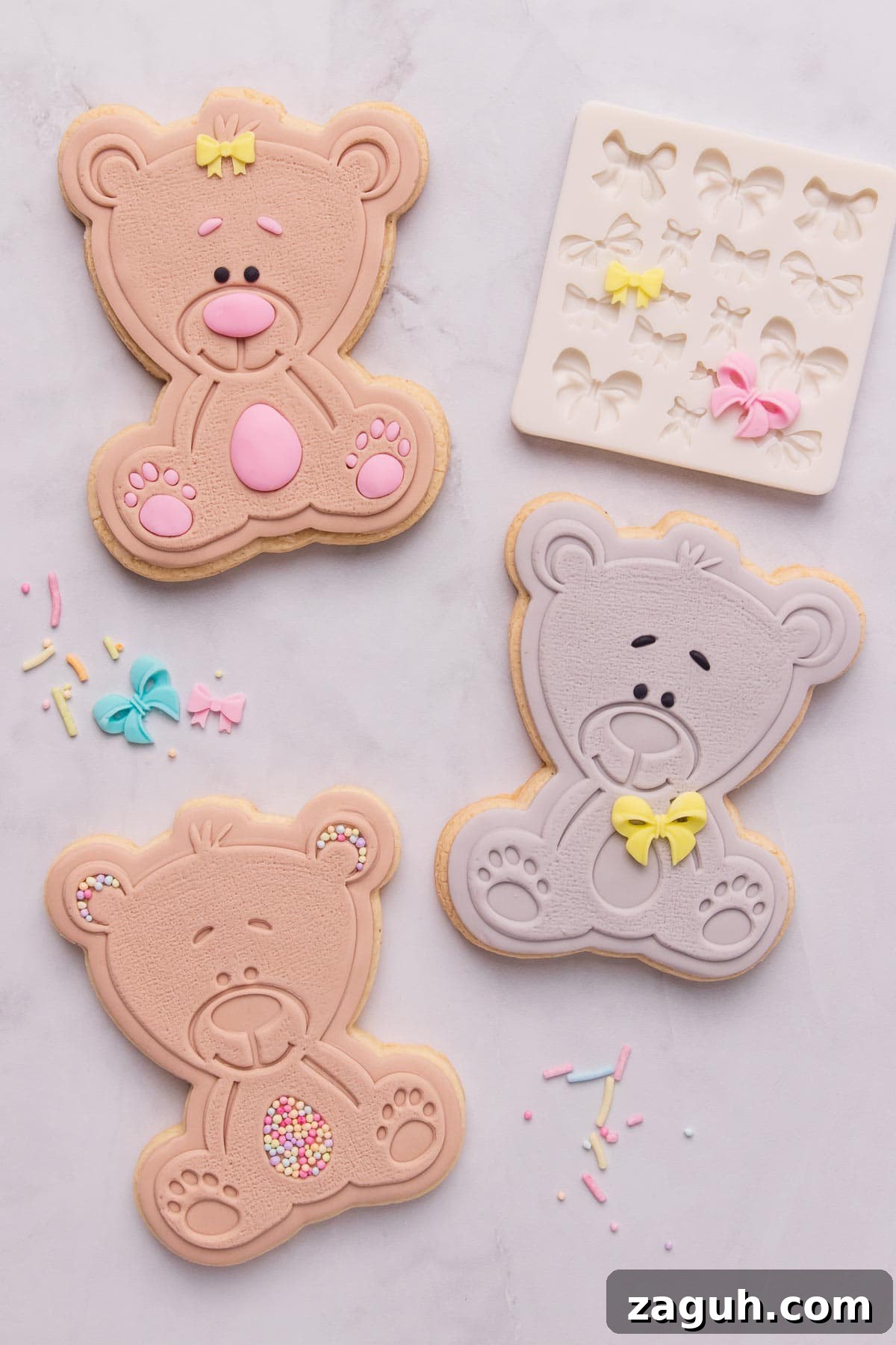 Stamped Fondant Cookies: Step-by-Step Guide for Beautiful Designs 11 Three teddy bear shaped stamped fondant cookies decorated with tiny bows and sprinkles.
